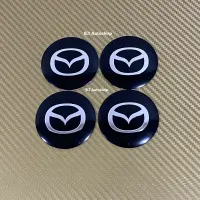 โลโก้ฝาครอบล้อ โลโก้ติดดุมล้อ MAZDA ( s ) ขนาด : เส้นผ่าศูนย์กลาง 56 mm (ราคาต่อชุด มี 4 ชิ้น )