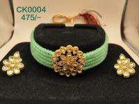 Gold-plated and stone studded handcrafted choker necklace secured with drawstring closure &amp; matching earrings