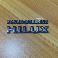 โลโก้ Hilux+POWER STEERING ติดแก้มข้าง สีเงินขอบดำ ชุด 2 ชิ้น