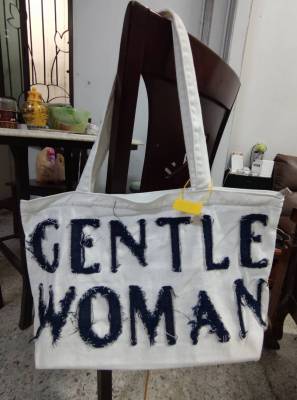 กระเป๋าผ้าสีขาว ปักลายด้วยผ้าสีน้ำเงิน คำว่า GENTLE WOMAN
