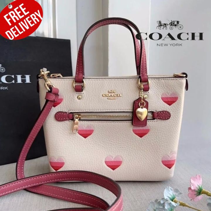 Coach Mini Gallery crossbody with stripe heart print.