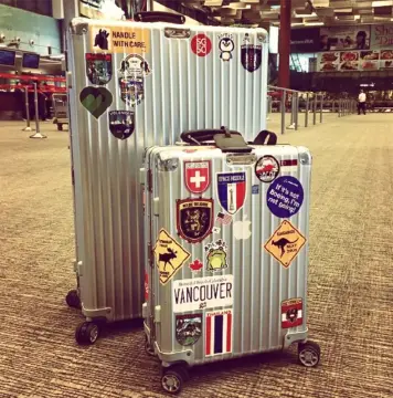 Travel trolley suitcase @rimowa with stickers🧳 and Louis Vuitton travel  bag👜 @clairerose