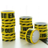 In the bottom of the yellow color warnings tape English letters warning mark adornment big 4.8 CM long 25 meters wide