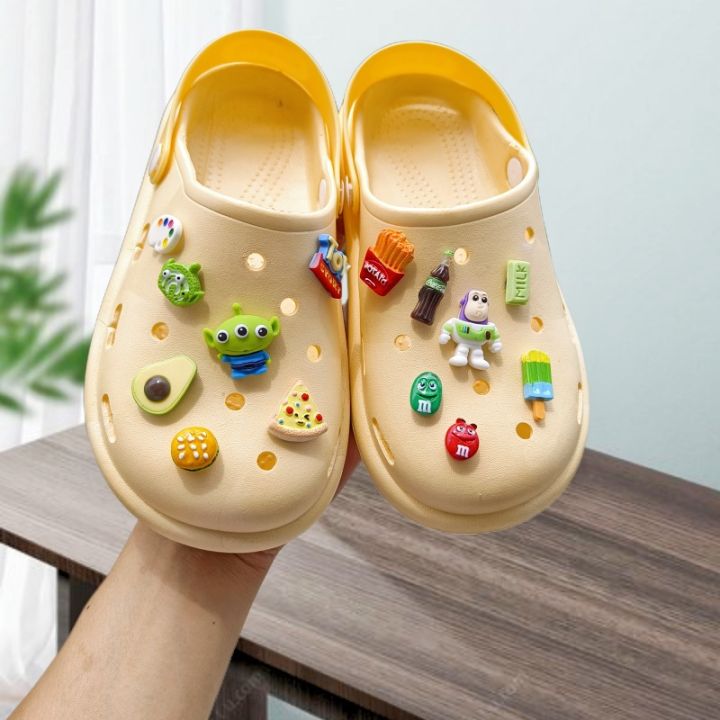 Yellow crocs with on sale charms