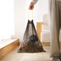 Disposable garbage bag with automatic drawstring closure