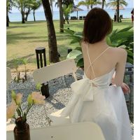 Sexy v-neck white female summer bowknot backless dress skirt with shoulder-straps dress seaside on a white sand beach