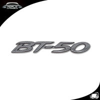 โลโก้ Logo "BT-50" สี Black Carbon BT-50 Mazda 2, 4 ประตู ปี2012 - 2018 ขนาด 3.5x21x05 มีบริการเก็บเงินปลายทาง