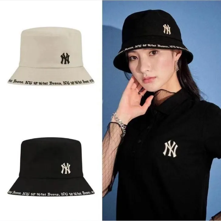 A model wears an all black outfit - New York Yankees bucket hat