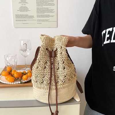 New hollow out straw bucket bag spring 2022 large capacity woven bag with drawstring seaside on his single shoulder bag