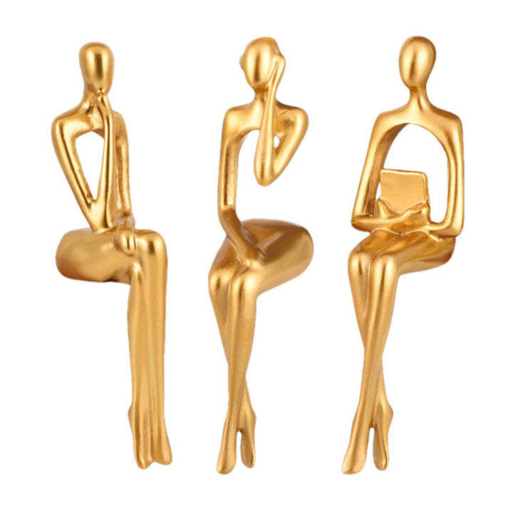 golden abstract sitting sculpture