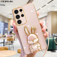 NORVIK เคสโทรศัพท์เคลือบสีชมพูสุดหรูพร้อมที่ยึดคันชักกระต่ายนำโชคและ A24สายคล้องสำหรับ Samsung Galaxy A54 A34 S23 S23 A14 A33 A73 A53 A04S A13 A22 LTE Plus Ultra 4G 5 n1-2ปิดปลอกอ่อน G