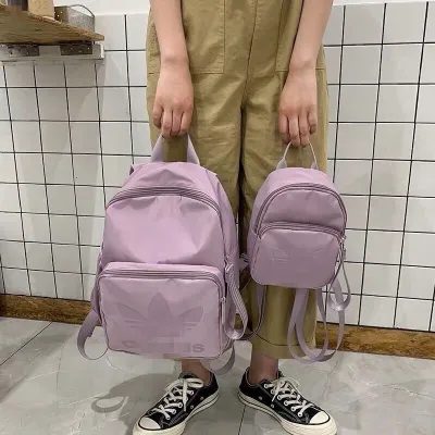 Adidas [สองขนาด] กระเป๋าเป้สะพายหลังสีม่วง Clover Taro สำหรับคู่รักและเด็กใช้ได้