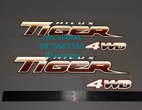 สติ๊กเกอร์แบบดั้งเดิม ติดข้างกระบะ TOYOTA TIGER 4WD ปี 2003 สะท้อนแสง 3M แท้ คำว่า HILUX TIGER 4WD 1 ชุด มี 2 ชิ้น sticker แต่งรถ ติดรถ โตโยต้า ไทเกอร์ สีส้ม ส้ม