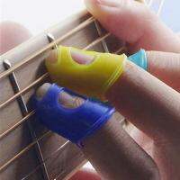 【The-Best】 Al-Kitaab 4Pcs กีตาร์ Fingertip Protector Fingerstall ซิลิโคนกีตาร์ Finger Guard Protection Press อุปกรณ์เสริมสำหรับ Ukulele Guitar