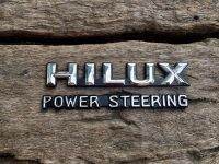 โลโก้ HILUX POWER-STEERING  โลโก้ไฮลักษ เพาเวอร์ ติดข้างแก้ม สีชุบ-ดำ (งานเทียบ) โตโยต้า HILUX MIGHTY-X LN 85-111 SR-5 1989-1998