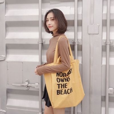 koreafashionshop(KR1783) กระเป๋าผ้าใบใหญ่ NOBODY OWNS THE BEACH ผ้าแคนวาสมี4สาย