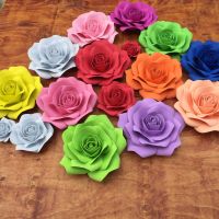 The background of the wedding party is decorated with handmade flowers Popular design giant wedding occasion paper flowers