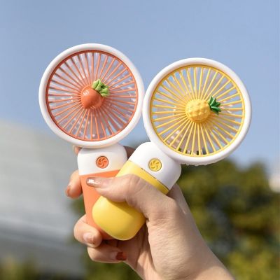 Cute vegetable and fruit handheld portable mini fan with mobile phone holder function charging fan, suitable for outdoor or indoor student dormitory office desks.