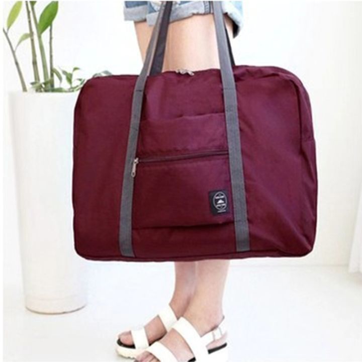 loose-กระเป๋าเก็บเดินทาง-พับเก็บได้-กระเป๋าถือ-และสามารถหิ้วได้หรือนำไปเสียบบนแกนกระเป๋าเดินทางเพื่อลาก-ผ่อนแรงได้