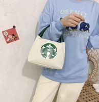 The Starbucks hand-held canvas bag can hold umbrellas, insulated cups, and a portable cell phone pocket. handy bag