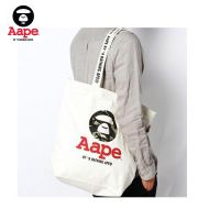 กระเป๋าผ้าใบสีขาวความจุขนาดใหญ่ Aape แบบพกพากระเป๋าช้อปปิ้งแบบพกพาไหล่เดียวกระเป๋าสิริ