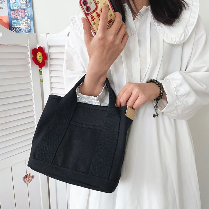 koreafashionshop-kr1819-กระเป๋าผ้าแคนวาส-กระเป๋าถือ-ผ้าแคนวาส-ขนาดเล็ก-จุของได้เยอะ-พกพาง่ายแบบหนามีช่องด้านหน้า