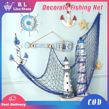 Decorative sea life in a fishing net  Fish net decor, Mermaid bathroom  decor, Fishing decor
