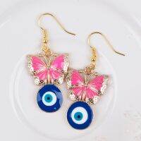 ต่างหูแฟชั่น ผีเสื้อชมพูอีวิลอาย โลหะสีทอง  ขนาด 50x21mm , 1 คู่