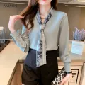 AMMIN Tops 2021 new autumn V-neck tie long-sleeved button cardigan commuter printed chiffon shirt women&#39;s Korean retro Hong Kong-style print loose simple long-sleeved elegant temperament commuter solid color all-match blouse. 