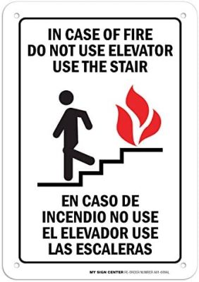 ในกรณีที่เกิดเพลิงไหม้ห้ามใช้ลิฟต์ใช้บันไดภาษาอังกฤษและป้ายภาษาสเปน X อลูมิเนียมปลอดสนิมและ A-AL จาก UV
