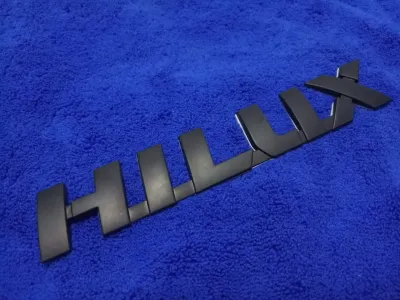 AD.โลโก้ HILUX (REVO) สีดำ 3.5×21cm  1ชิ้น