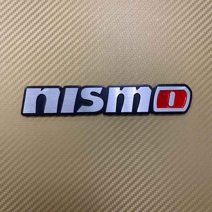 โลโก้* nismo สีเงินขอบดำ งานอลูมิเนียม ขนาด* 2.8 x 16 cm ราคาต่อชิ้น