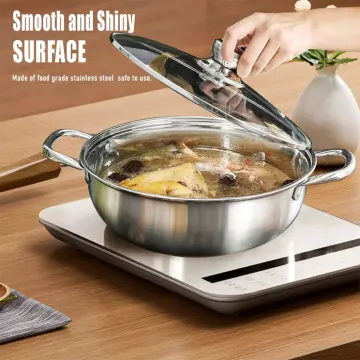 Shiny stainless steel soup pot, covered a lid transparent glass