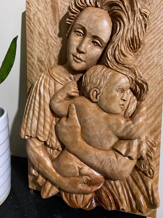 "A MOTHER’S LOVE", carved in solid Mahogany wood. It shows the special