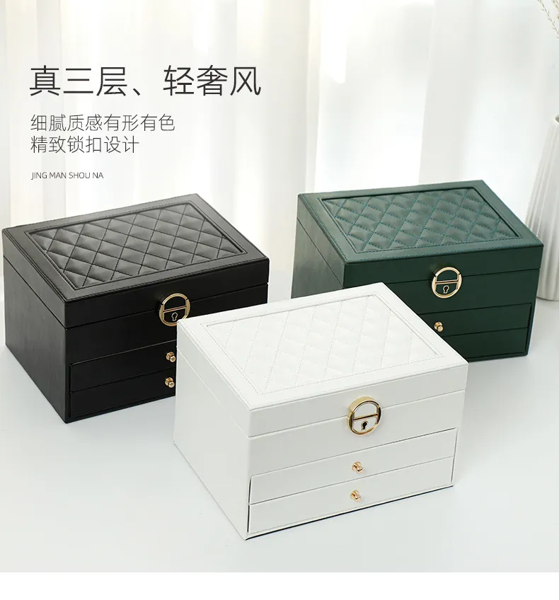 A BLACK LAMBSKIN LEATHER QUILTED JEWELRY BOX WITH GOLD HARDWARE