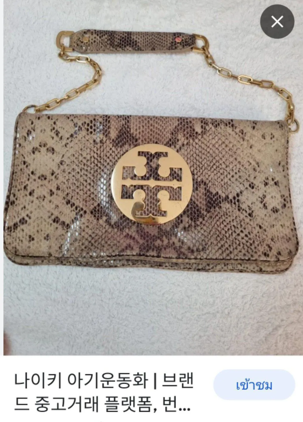 Tory Burch? Snakeskin Clutch/Shoulder BagTory Burch Reva  กระเป๋าคลัช/สะพายหนังงู. กระเป๋าซิปทั้งสองด้านปิดด้วยแม่เหล็ก  สายโซ่ถอดออกได้วัสดุ: หนังสัตว์ สี: สีเบจ/ทอง ขนาด: สูง17 ซม. x กว้าง31 ซม.  X ลึก4 ซม. 