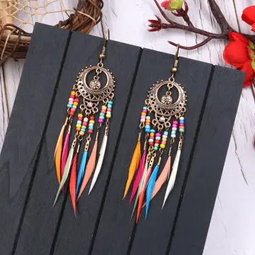 Dream catcher earrings with feathers, threads, and beads strung on a rope.  dreamcatcher created by hand. Generative AI Stock Illustration | Adobe Stock