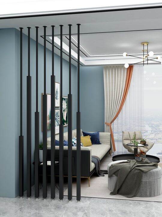 The wrought iron screen partitions the living room, which is modern and