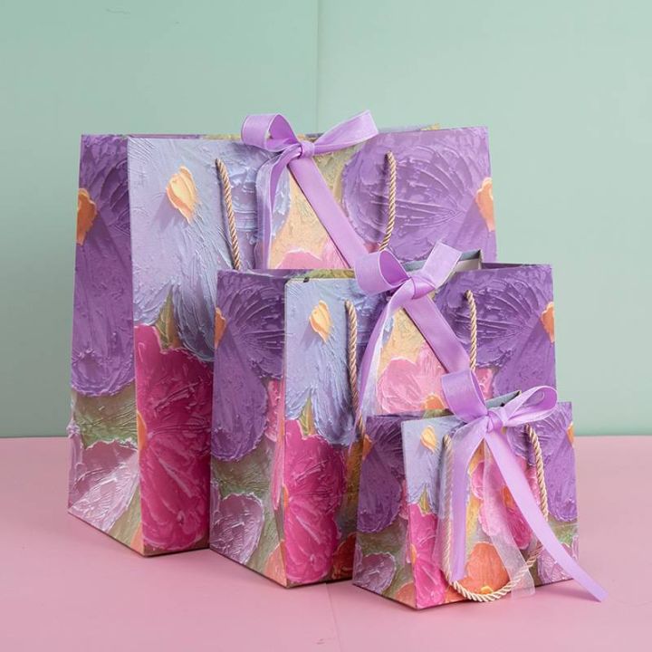 พร้อมส่ง-ถุงกระดาษ-ม่วงลายดอกไม้หลากสี-ถุงของขวัญ-พร้อมโบว์ผูก-มินิมอล-minimal-ถุงแฟชั่น-งานสวยมากๆ