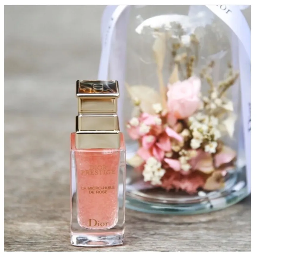 Bottle of Rose Oil Dior Prestige La Micro-huile De Rose on White
